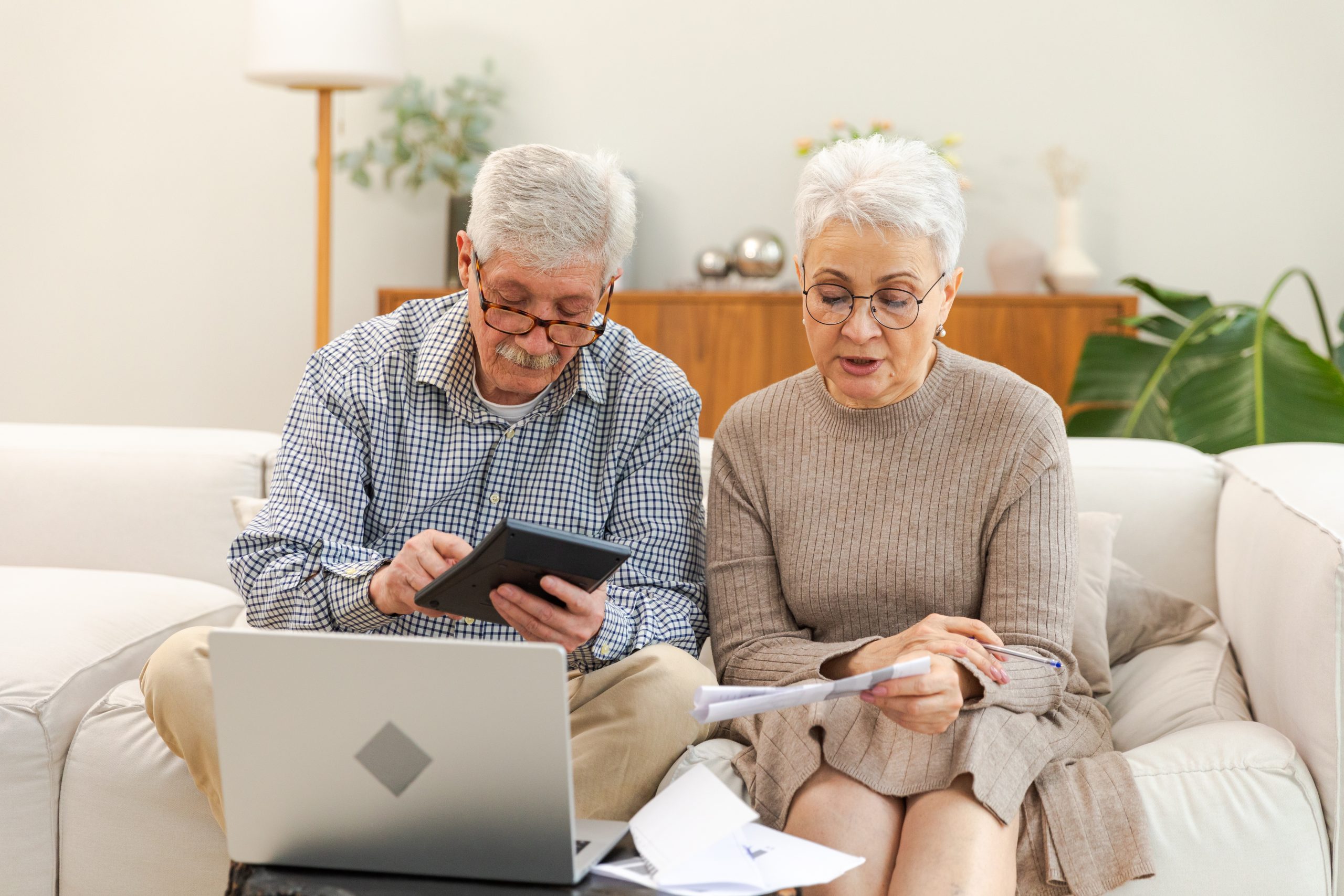 Older couple sitting on a couch-making plans