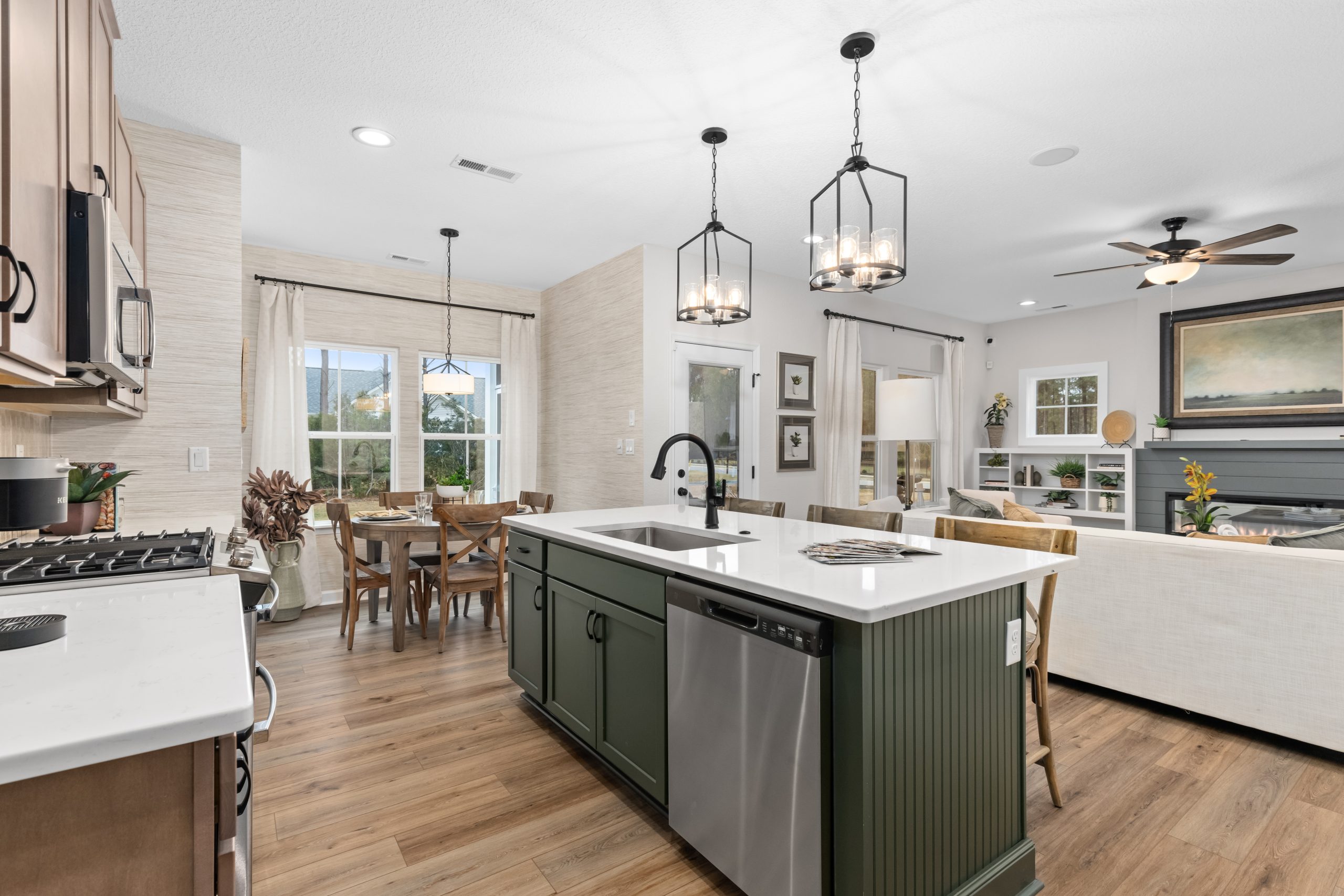 Open-concept kitchen and living room seamlessly connect to a cozy dining area, creating a spacious and inviting atmosphere